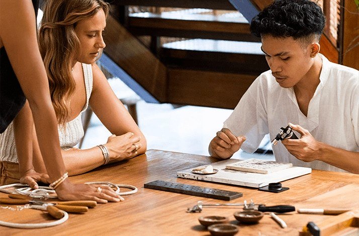 Jewellery-making workshop at John Hardy in Bali with tools on a wooden table.