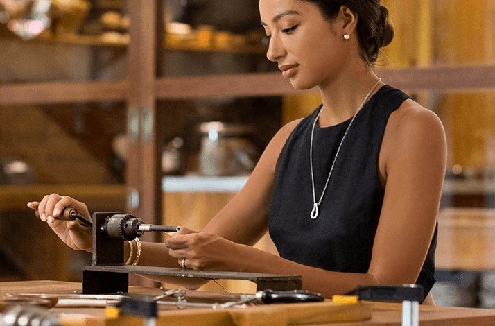 Participant using a jewelry crafting tool at John Hardy workshop in Bali.