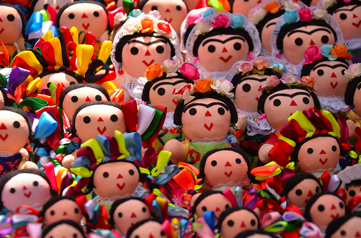 Puppets designed in the likeness of Frida Kahlo, featuring her signature style, iconic unibrow, and vibrant accessories.