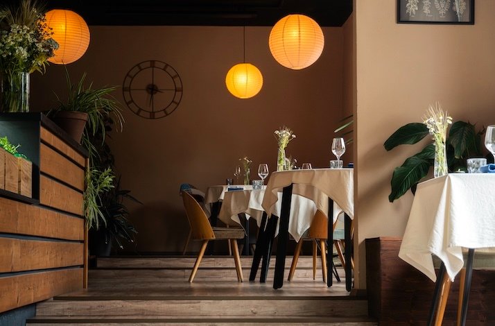 Intimate dining space with soft lighting, earthy decor, and a welcoming ambiance at Leaf Restaurant