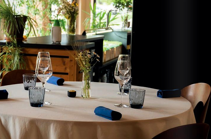 A set dining table with wine glasses inside LEAF restaurant.