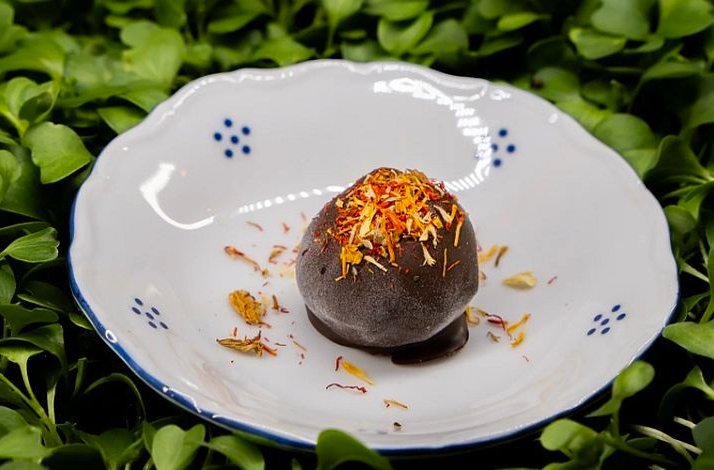 A vegetarian chocolate dessert course at LEAF restaurant, decorated with edible flowers.