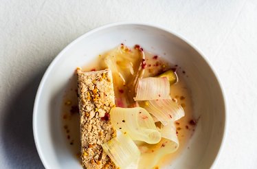 Elegant dessert with crumbly topping and fresh rhubarb ribbons in a delicate sauce at Leaf Restaurant