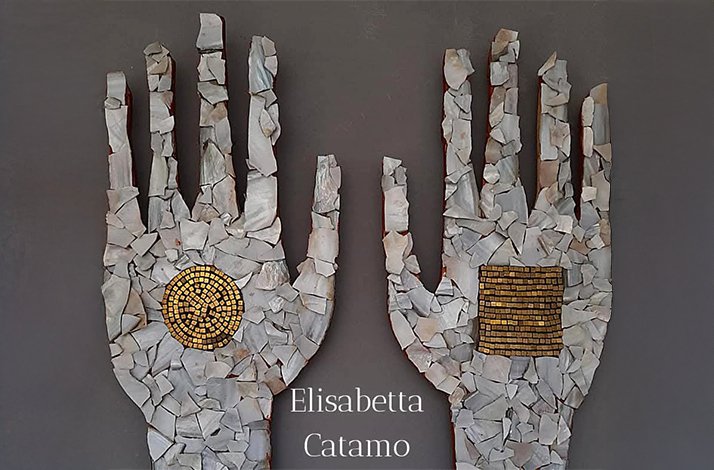 A wall decorated with pieces of stones shaping two human hands at private atelier of artist Elisabetta Catamo.