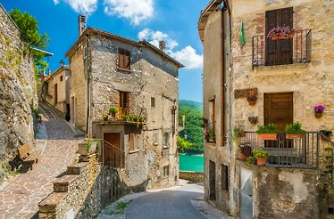 A narrow street with stone houses built along the street in  Castel di Tora, Italy.