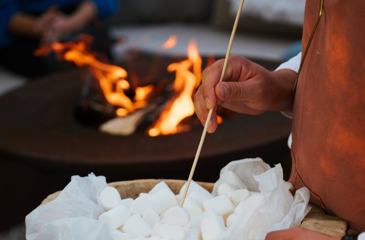 Close up of a chef preparing to toast marshmallows