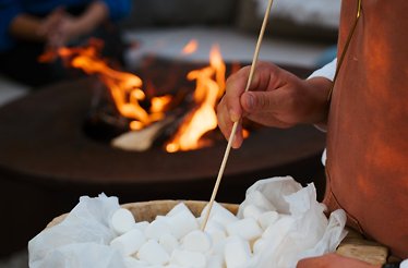 Close up of a chef preparing to toast marshmallows