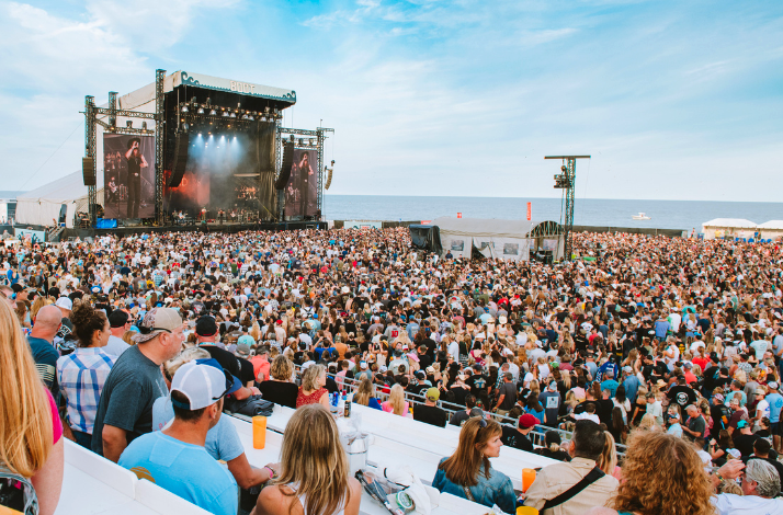 Ocean view at daylight of a band performing live on stage at Country Calling festival from the viewing deck.