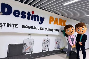 Entrance of Destiny Park, featuring its logo and themed decor, with suitcases symbolizing knowledge and professions.