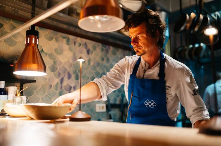 Chef at Konoba Zijavica in Mošćenička Draga preparing a dish.