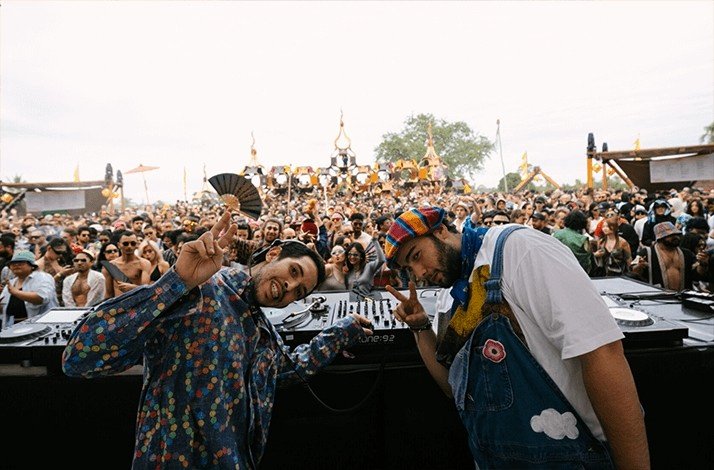 DJs performing in front of a lively crowd at Wonderfruit festival in Thailand.