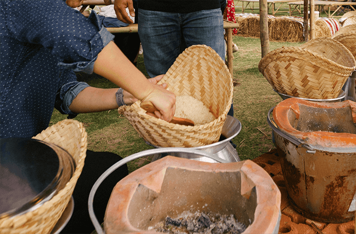 Someone preparing a traditional Thai dish, a type of sticky rice