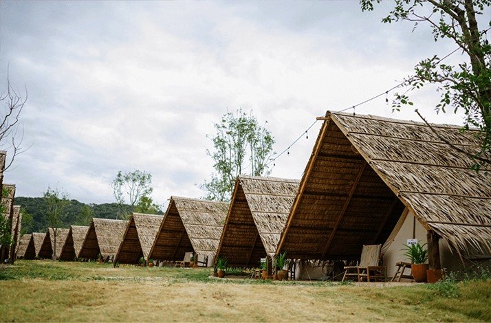 Big traditional wooden tents lined up in Wonderfruit's boutique camping area.