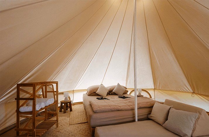 Interior view of the sleeping area inside Wonderfruit's boutique camping tent.