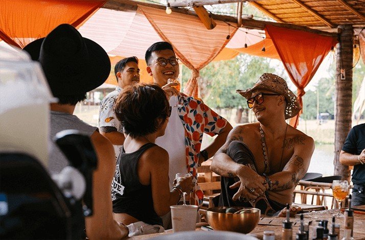 A group of people having their conversations at the Wonderfruit's boutique camping area.  