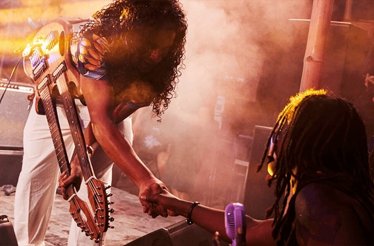 Musician with double-neck guitar at Wonderfruit festival in Thailand.