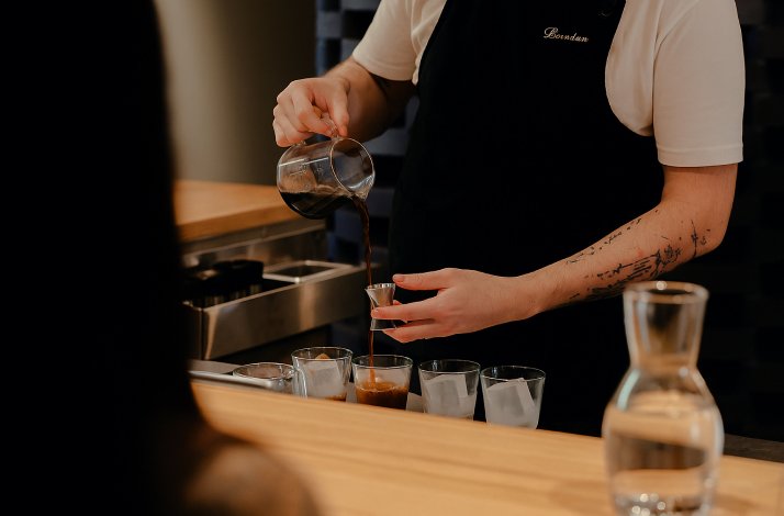 A barista serving a coffee