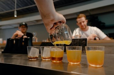 A barista serving different type of brewings