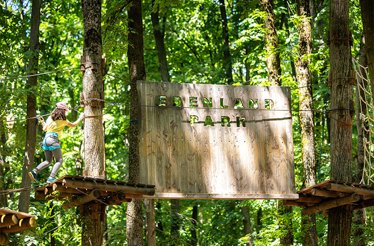 Edenland Park inscribed on a wooden plate on a Zip line stand at the park. 