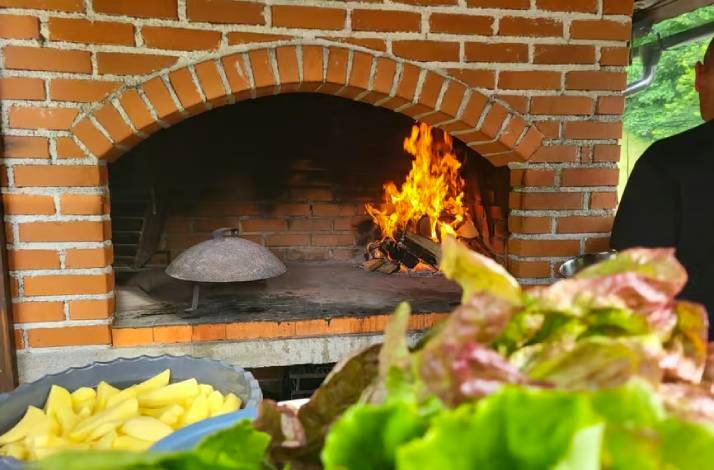 Brick stove with a glowing fire inside.