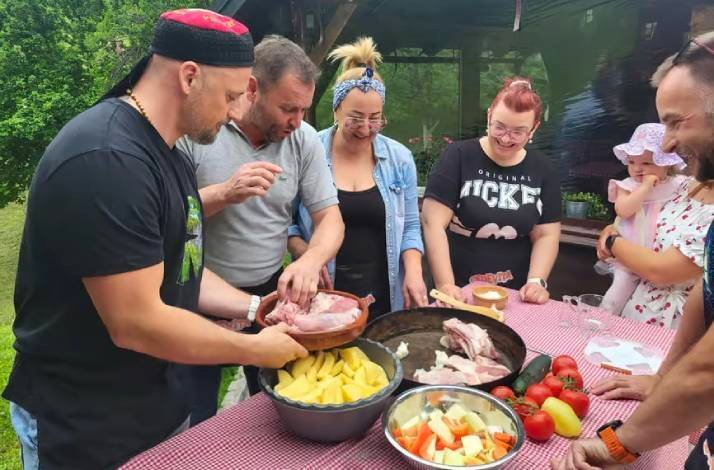 Group of people enjoying a hands-on cooking master class.