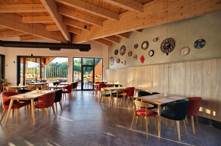 Dining area featuring panoramic windows and warm wooden decor.
