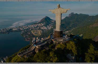 The iconic Christ the Redeemer statue overlooking Rio de Janeiro and lush mountains.