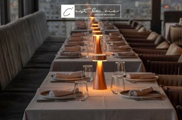 Elegant dimly-lit tables at C'est la Vie – Rooftop Restaurant.