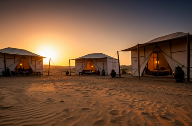 Cozy tents of Bedouin camp at sunset.