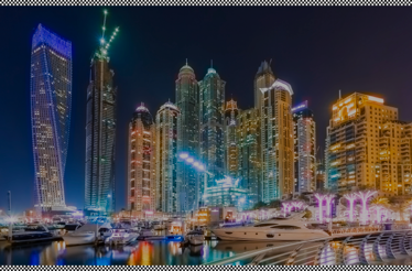 Scenic view of Dubai Marina skyline at night.
