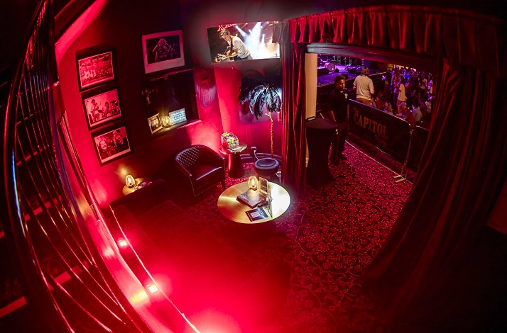 See Cage the Elephant live from the Stage Lounge at The Capitol Theatre: In Port Chester, New York The private Stage Lounge at The Capitol Theatre, featuring red ambience lighting and curated rock 'n' roll photography.
