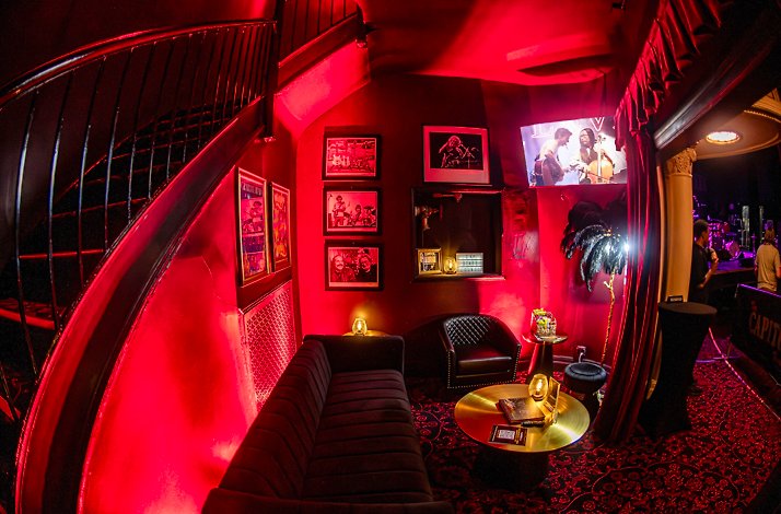 See Cage the Elephant live from the Stage Lounge at The Capitol Theatre: In Port Chester, New York The private Stage Lounge at The Capitol Theatre, featuring red ambience lighting and curated rock 'n' roll photography.