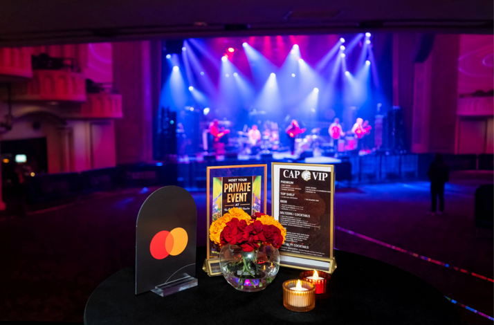   A table with a Mastercard logo and an excellent view of The Capitol Theatre stage from the VIP deck.