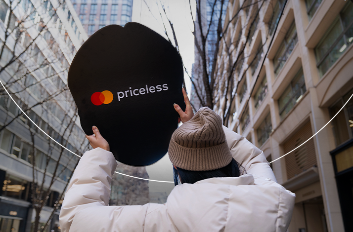 A fan holding a Priceless logo.