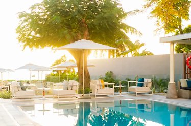Elegant seatings by the pool on a sunny day at 2Beach Club.