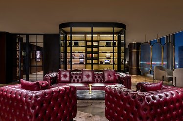 The sophisticated cigar and cocktail lounge at 42 Oak & Smoke, featuring aged leather seatings and ambient lighting.