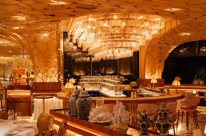 The elegant interiors of Mediterranean and Japanese Restaurant KIRA, featuring gold accents and hand-painted blue ornaments.