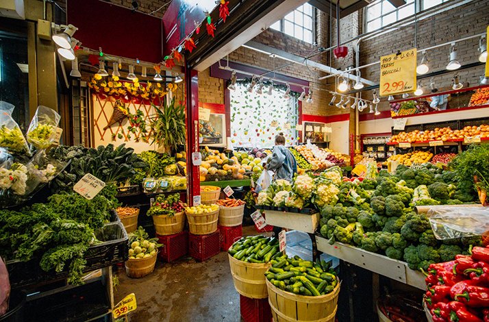 The inside scene of  St. Lawrence Market, showcasing variety of vegetables and fruits up for sale