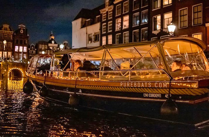 Elegant Pure Spirit on Amsterdam's glowing canals during the Light Festival.