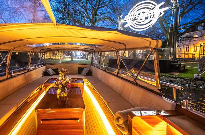 Inside picture of elegant seating and lighting setup in the Pure Spirit salon boat.