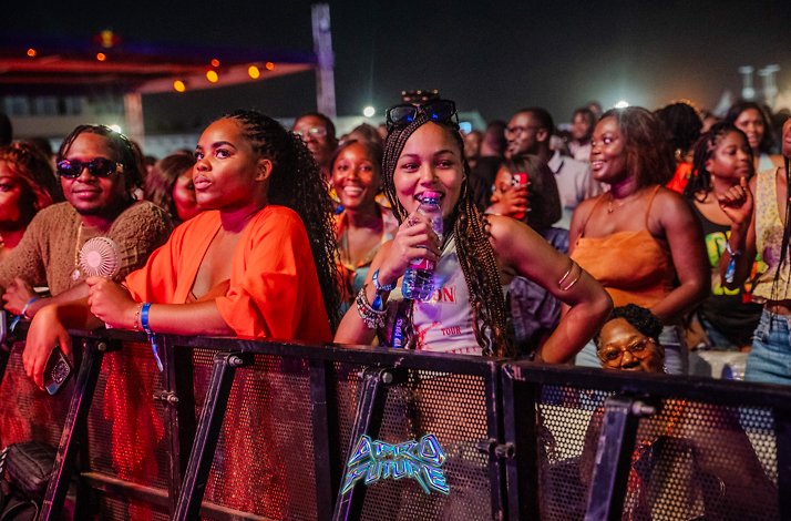 A group of crowds are enjoying at the AfroFuture concert, while standing behind a security barrier in El Wak Stadium.