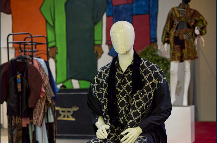 A mannequin dressed in a vibrant traditional African outfit, showcasing intricate patterns and cultural significance.