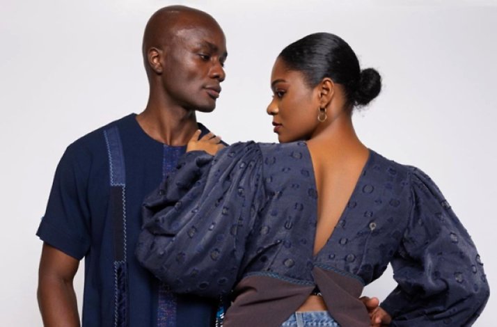 Two models posing on a white background in the clothes of of Ghana's top designers