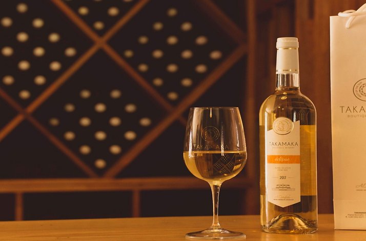 A glass with a bottle of wine from Takamaka Boutique Winery.