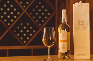 A glass with a bottle of wine from Takamaka Boutique Winery.