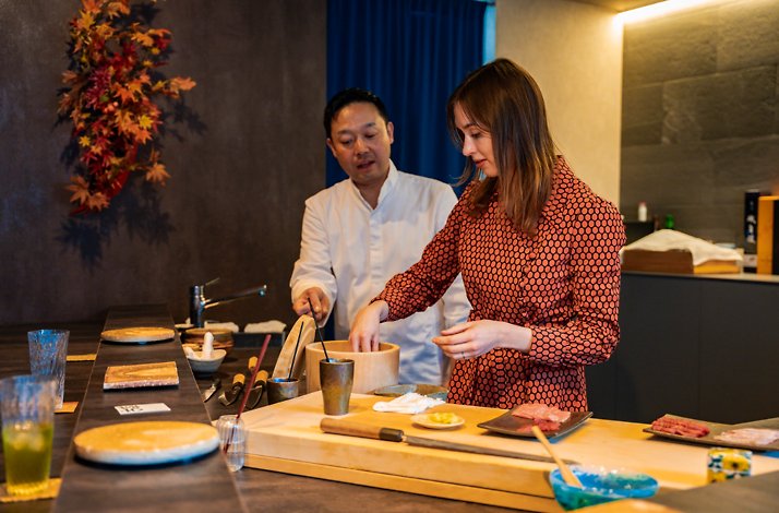 Sushi-making class at a private Tokyo restaurant with traditional tools and seafood.