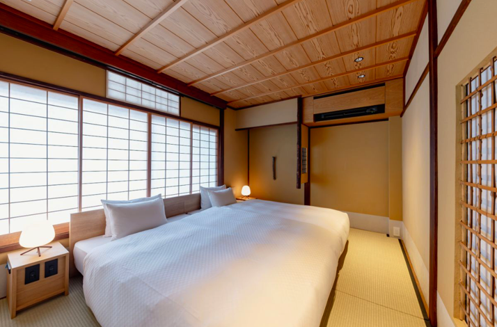 Queen size bed in traditional tatami room in restored 120-year-old villa in Kyoto’s Higashiyama district.