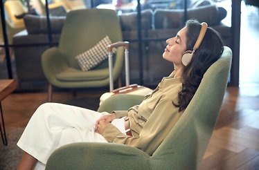 Woman relaxing in a chair with headphones on