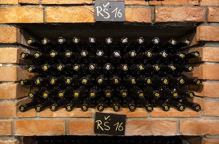 Wine bottles from the same vintage neatly arranged on a shelf at St. Claire’s Vineyard.
