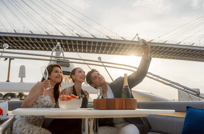 Three persons taking a selfie with a champagne bottle